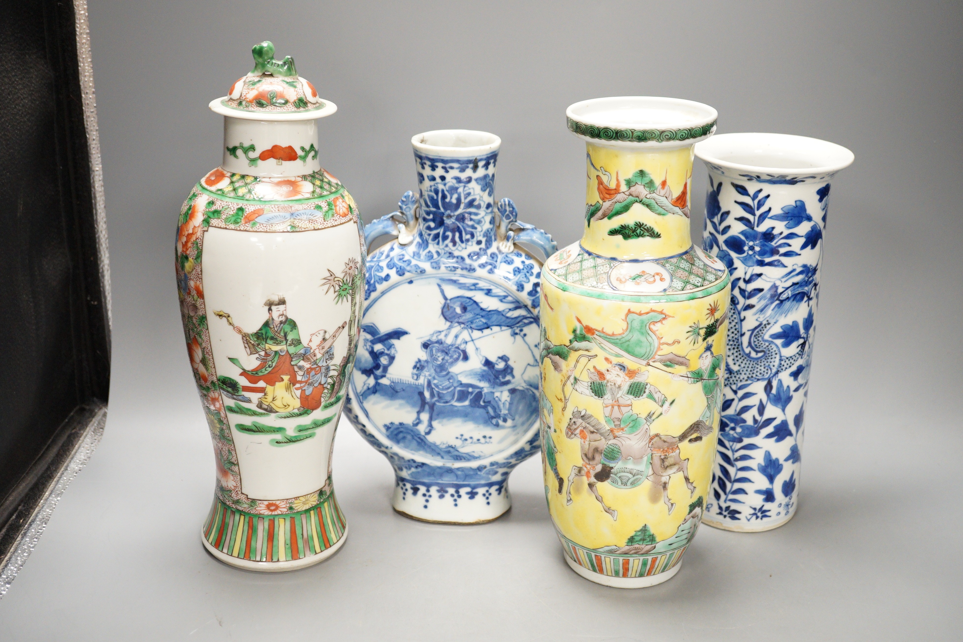 A Chinese famille verte vase and cover, a yellow ground ‘soldiers’ vase, a blue and white moonflask and a similar’dragon’ sleeve vase, all late 19th/early 20th century, Tallest 33cm
